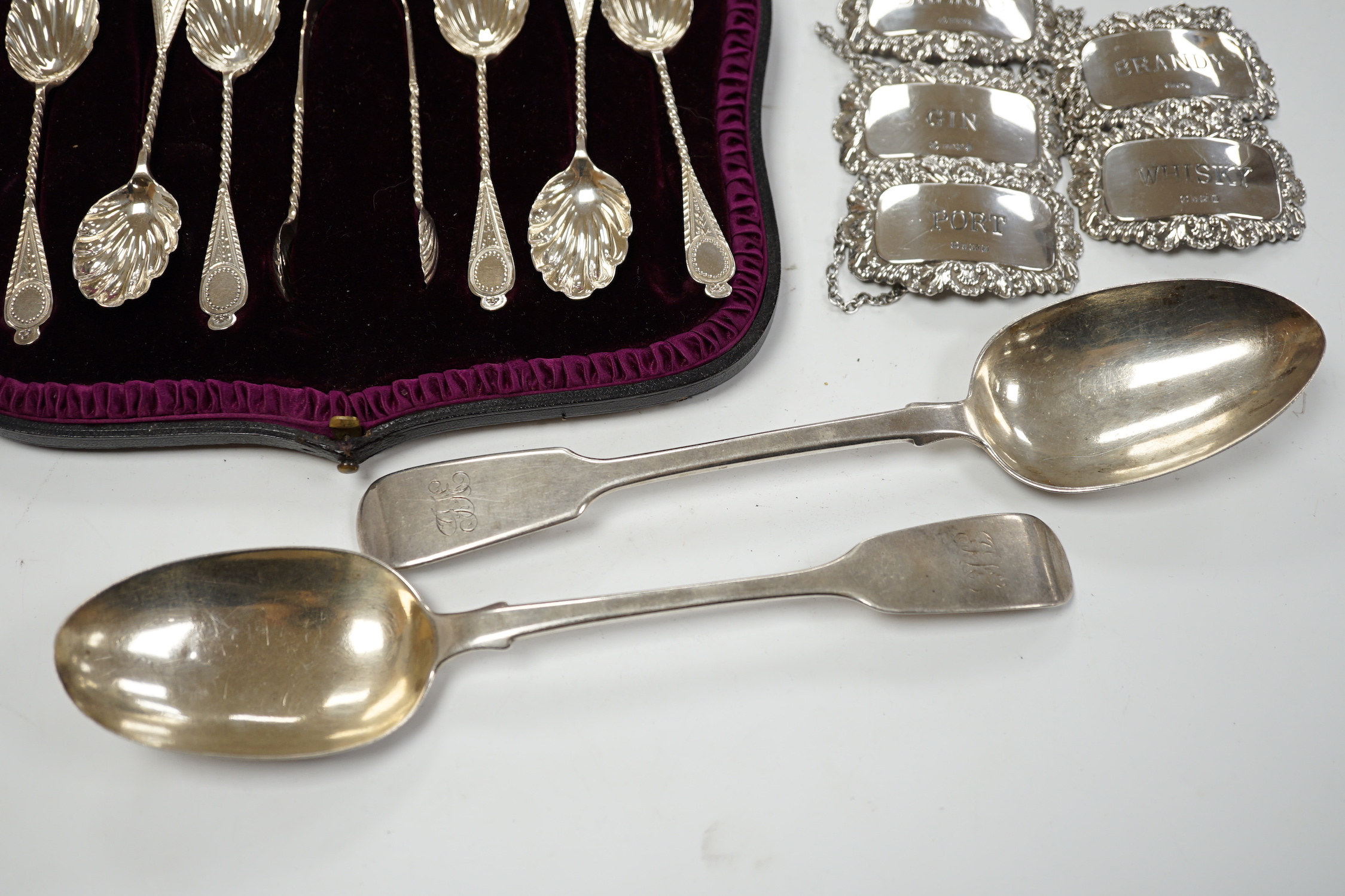 A matched set of five modern silver wine labels, Ray Hall, Sheffield, 1994(3), 1998 & 2000, 61mm, together with two Victorian silver fiddle pattern table spoons, London, 1856 & 1865 and a cased set of six silver coffee s